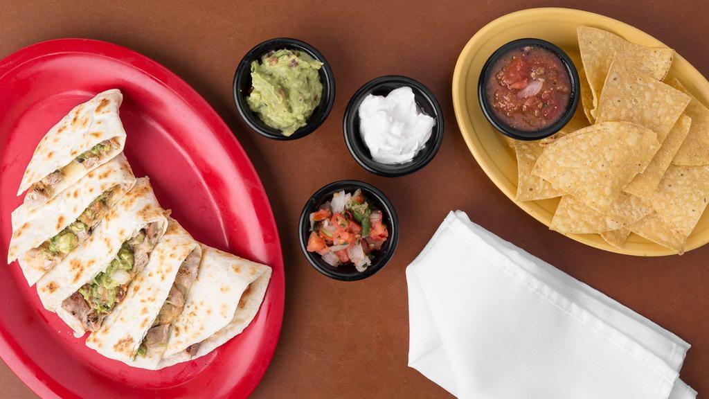 Chipotle Pork Quesadilla · Grilled pork, chunky guacamole, chipotle sour cream, melted Jack cheese, pico de gallo and chipotle sour cream. Served with a handful of chips and a side of salsa.