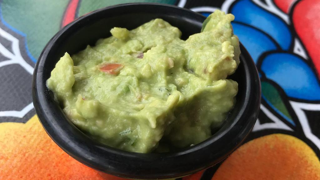 Side Of Chunky Guacamole · A condiment size portion of our housemade chunky guacamole.  Onion, lime, tomato, cilantro and jalapeno.