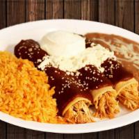Enchiladas De Mole · Chicken enchiladas with sweet mole”(a red sauce made of different types of sun-dried chilies...