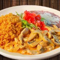 Pollo A La Crema · Strips chicken breast, sauté with jalapeño pepper, tomatoes, onions, and sour cream sauce, s...