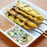 Chicken Satay · Chicken marinated in coconut milk, curry powder on a skewer. Served with peanut sauce and cu...