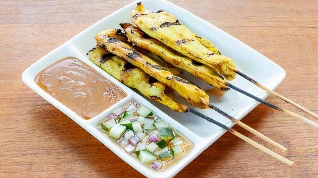 Chicken Satay · Chicken marinated in coconut milk, curry powder on a skewer. Served with peanut sauce and cucumber salad.