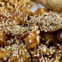 Sesame Chicken (Spicy) · Sliced chicken marinated in red sesame sauce with chili flakes and topped with sesame seeds....