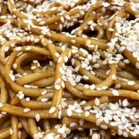 Sesame Noodles · Lo mein noodles marinated in sesame sauce and topped with sesame seeds