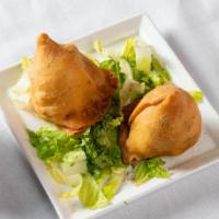 Vegetable Samosa · Savory deep fried pastry puffs filled with mildy spiced potato and peas.