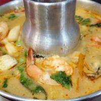 Tom Yum (Hot & Sour) · A hot and sour soup with galangal, mushrooms, onion, baby corn, tomatoes, lemon grass, bell ...