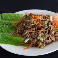 Laab · Ground meat tossed with onion, cilantro, scallion, and seasoned with a zesty and spicy lemon...