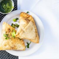 Vegetable Samosa · Vegan. Crisp pastry filled with potato, peas, spices, and deep fried.