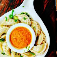 Chicken Momo · Dumplings made with ground chicken mixed with herbs.