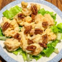 Honey Walnut Prawn · Deep-fry prawn with walnuts in a sweet mayo sauce over a bed of cabbage.