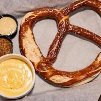 Pretzel · 10 oz Bavarian pretzel served with house-made cheese sauce, honey mustard and stone ground m...
