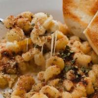 Mac And Cheese · Smoky, creamy cheese sauce topped with garlic and herb bread crumbs toasted to perfection