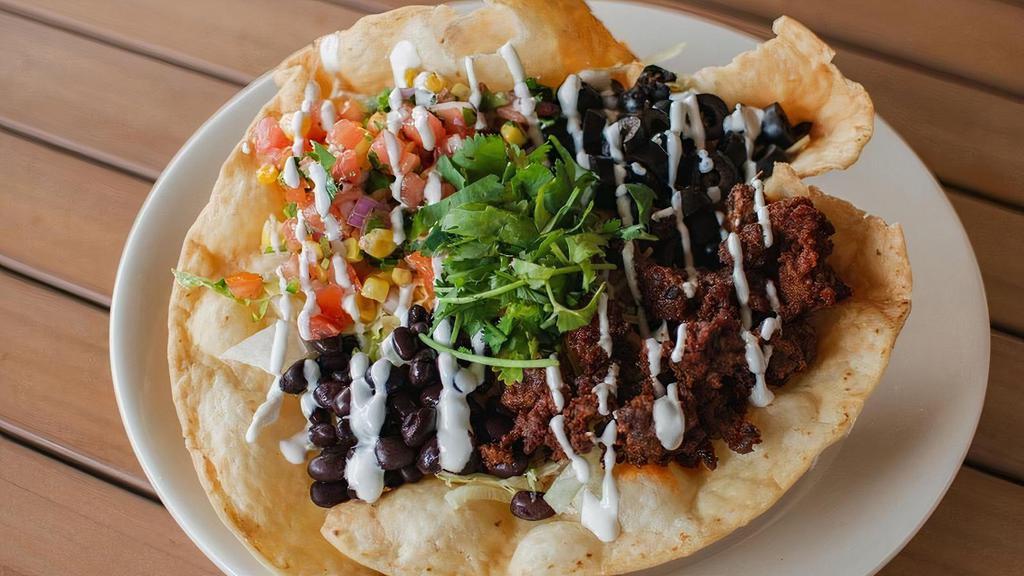 Taco Salad · Fried crispy tortilla shell, filled with salad mix, cheese, olives, black beans, chorizo, sour cream and pico de gallo