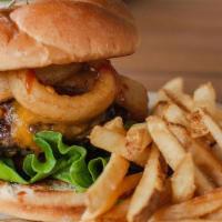 Cowboy Burger · 6 oz hand-pressed chuck brisket patty with house seasoning, topped with cheddar, onion rings...