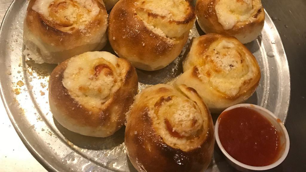 Pepperoni Rolls · 8 pieces. Pepperoni, mozzarella and Parmesan rolled in fresh dough and baked. Served with a side of our homemade marinara sauce.