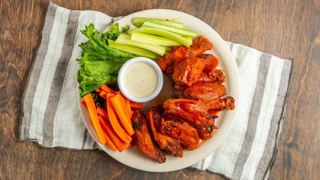 Wings · Choose from traditional buffalo wings only hotter or BBQ wings, all served with carrots, celery and bleu cheese dressing.