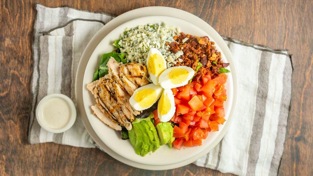 Cobb Salad · Sliced egg, chicken breast, Gorgonzola cheese, avocado, bacon and tomatoes on a bed of fresh mixed greens. Served with your choice of dressing on the side.
