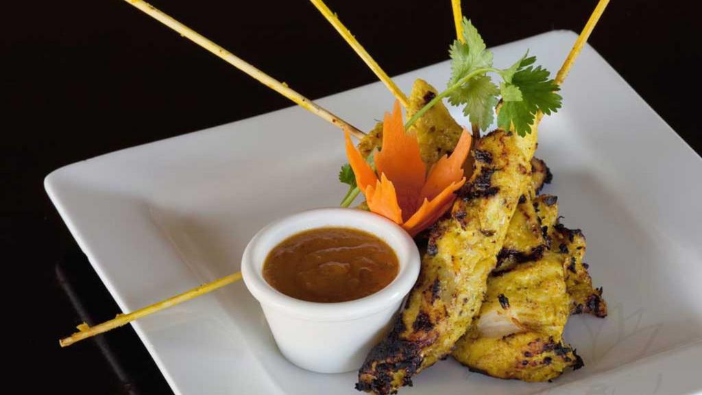 Chicken Satay (5 Pieces) · Gluten-free. Marinated tender chicken breast seasoned and grilled to perfection on traditional wood skewers and paired with creamy peanut sauce.