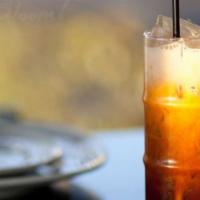 Thai Iced Tea (16Oz) · Enjoy this classic taste of Thailand: a sweet, slow-brewed iced tea topped with a layer of c...
