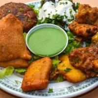 Vegetarian Delight · A selection of Samosa, Vegetable Pakora, Paneer Pakora, and Vegetable Cutlet. Served with ci...
