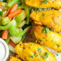 Shish Taouk · Delicious chicken marinated in garlic, oregano, saffron, and other Middle Eastern spices. Se...