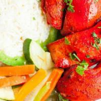 Tandoori Chicken Tikka · Boneless succulent pieces of chicken rubbed with Indian herbs and spices. Served with basmat...