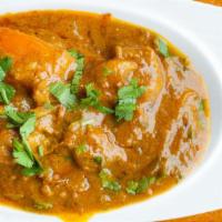 Curry Specialties Chicken · A traditional brown curry prepared with chicken, tomatoes, onions, and fresh herbs.