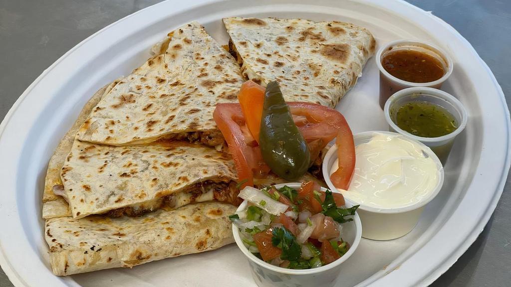 Quesadilla · Large flour tortilla served with Mozzarella cheese, meat, sour cream, pico de gallo and sauce on the side.