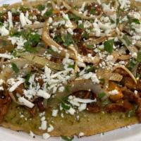 Huarache · Handmade corn tortilla with pinto beans, sauce, your choice of meat, Mexican cheese, cilantr...