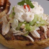 Sopes · Handmade corn tortilla with pinto beans, sauce, Mexican cheese, meat, cilantro, onions, sour...