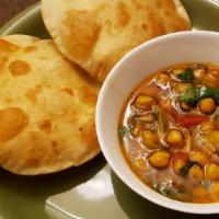Chole Bhatore · Meal with spicy chickpeas curry chole and 2 bhatoras (fried Indian bread).