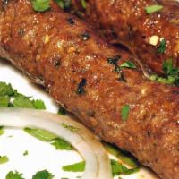 Seekh Kebab · Minced lamb marinated in fresh herbs and charcoal grilled on a skewer.