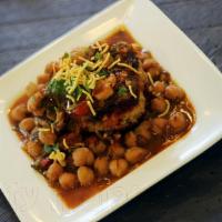 Aloo Tikki Chole · Potatoes croquette topped with chickpea curry, and chutney.