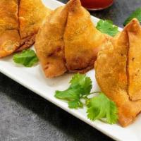 Kema Samose · Triangular pies stuffed with cooked minced meat.