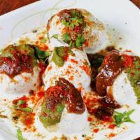 Dahi Bhalla Chaat · Spongy lentil  balls covered with whipped yogurt, aromatic spices, and chutneys.