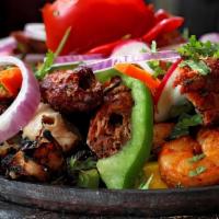 Tandoori Mixed Grill · Tandoori chicken, tandoori shrimp chicken tikka, seekh kebab, and boti kebab. Two pieces each.