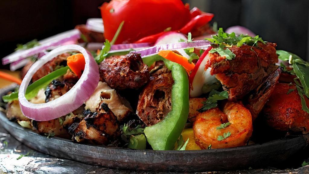 Tandoori Mixed Grill · Tandoori chicken, tandoori shrimp chicken tikka, seekh kebab, and boti kebab. Two pieces each.