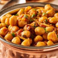 Chana Masala · Vegetarian. Savory Indian chickpeas cooked in semmered tomato and onion sauce. Served with b...
