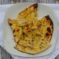 Garlic Naan · Traditional naan bread, subtly flavoured with select garlic.