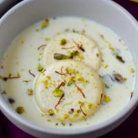 Ras Malai · Soft dough balls dropped into simmering milk cream, sugar syrup, and milk with saffron and p...