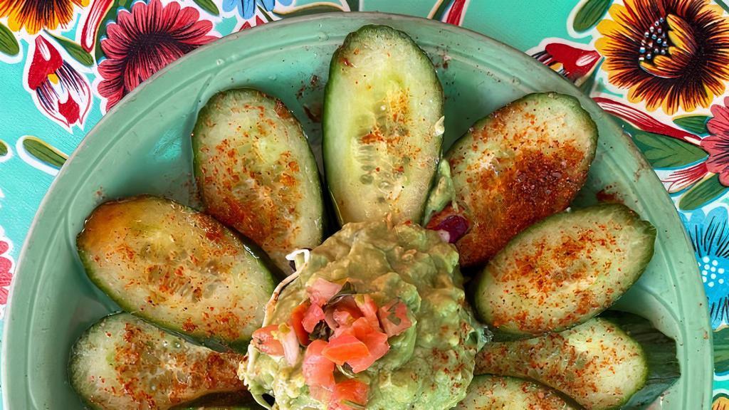 Spicy Cucumbers · Sliced cucumbers with fresh-squeezed lime juice & a sprinkle of spicy chile salt, topped with cabbage & pico de gallo - add on guacamole (pictured) for a delicious snack!

**VEGAN & GLUTEN-FREE**