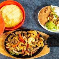 Fajitas · Chicken or steak fajitas served with grilled onions, grilled peppers, beans, rice, lettuce, ...