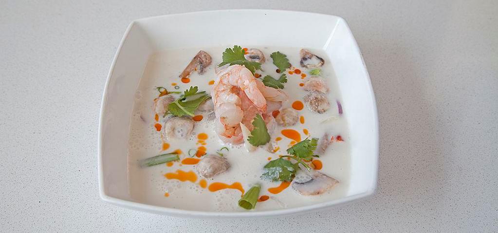 Tom Kha / Coconut Soup · Lemongrass, galangal, limes leaf, cabbages, tomatoes, mushrooms, and lime juice.