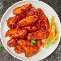 Buffalo Wings · Fresh chicken wings breaded, fried until golden brown, and tossed in medium buffalo sauce. S...