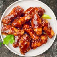 Jerk Wings · Fresh chicken wings breaded, fried until golden brown, and tossed in jerk sauce. Served with...