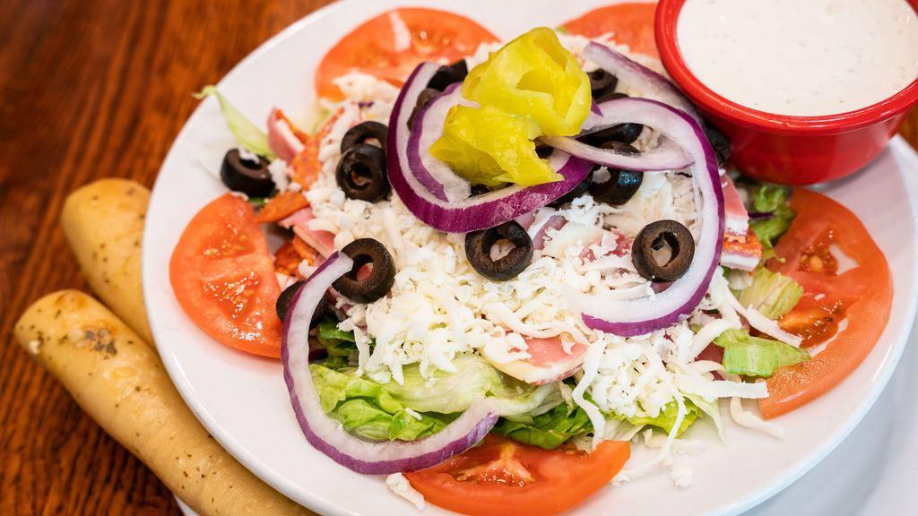Classic Antipasto · Hand sliced ham, salami, pepperoni and provolone with sliced tomatoes, black olives, red onion, mozzarella and pepperoncini, served over a bed of mixed greens.