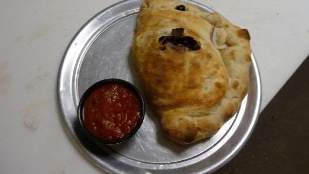 Calzone · The classic half-moon filled with ricotta cheese, our special blend of mozzarella cheeses, red onion, and your choice of topping. Additional toppings for an additional charge, we recommend no more than three additional toppings.