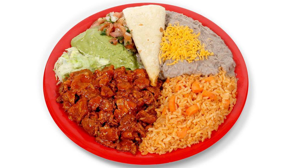 Combo #17 (Adobada Plate) · Marinated pork, lettuce, pico de gallo, guacamole, sourcream, and tortillas on the side with beans and rice.