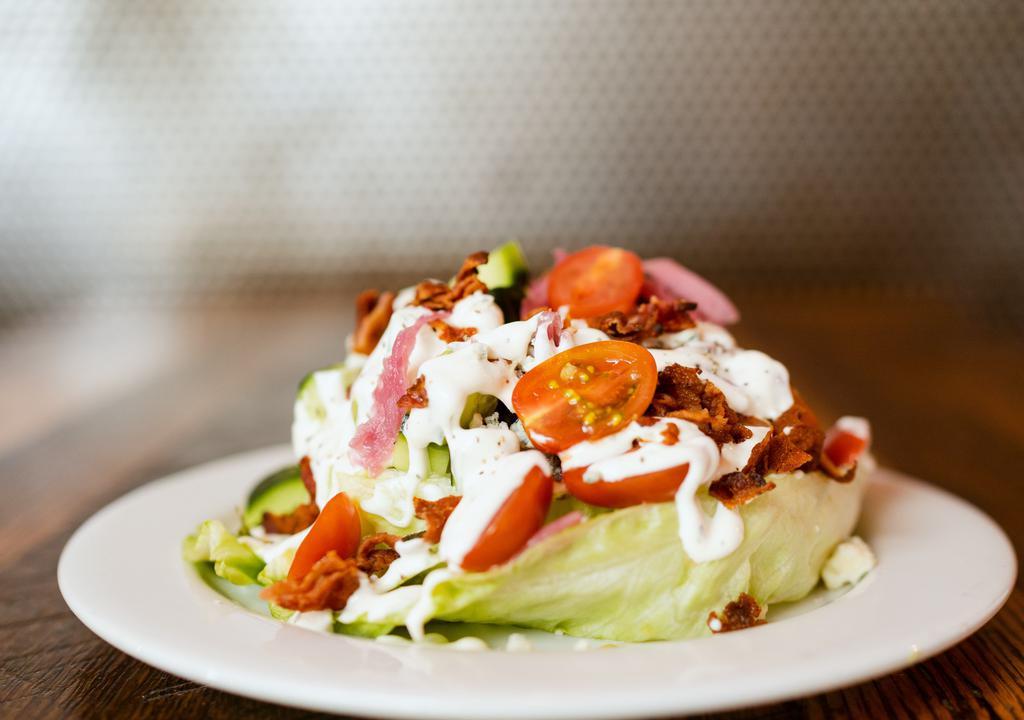 Wedge Salad · Iceburg Lettuce, Pickled Red Onion, Applewood Smoked Bacon, Tomato, Diced English Cucumber, Bleu Cheese Crumbles, Bleu Cheese Dressing