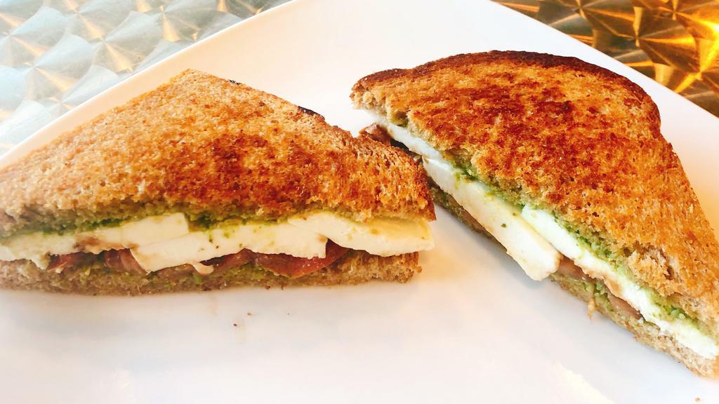 Caprese Sandwich · Pesto, fresh mozzarella, fresh basil, tomato, and a balsamic reduction on wheat bread